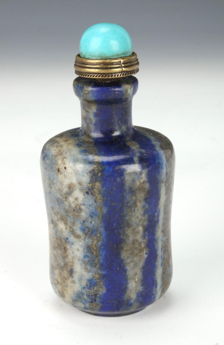 SODALITE SNUFF BOTTLE: SODALITE SNUFF BOTTLE: Snuff bottle with strong striations and markings. Turquoise stopper. 3" X 1 1/4" $100 - $200 Shipping: