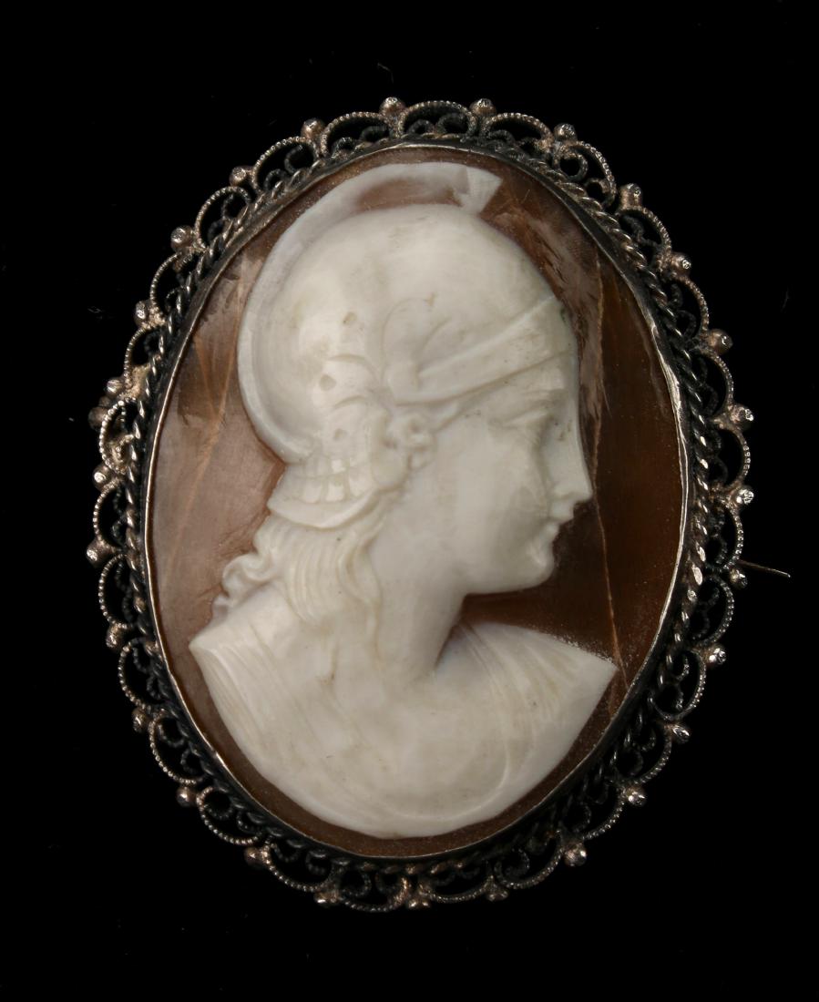 CARVED CAMEO IN STERLING FRAME ATHENA/MINERVA: CARVED CAMEO IN STERLING FRAME ATHENA/MINERVA: Shell cameo in a silver filigreed pin pendant frame. Beautifully carved. 1 1/2" $300 - $500 Shipping:<