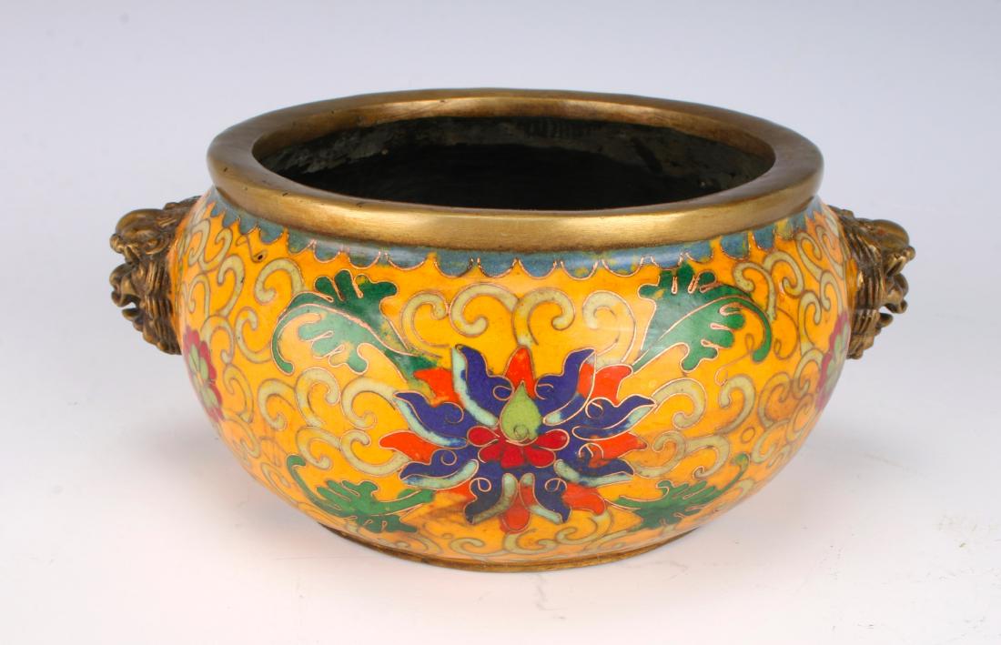 ANTIQUE CLOISONNE CENSER: ANTIQUE CLOISONNE CENSER: Orange background with brightly colored flowers and tendrils. Bronze lion handles. Marked on the bottom. 7" X 3" $400 - $600