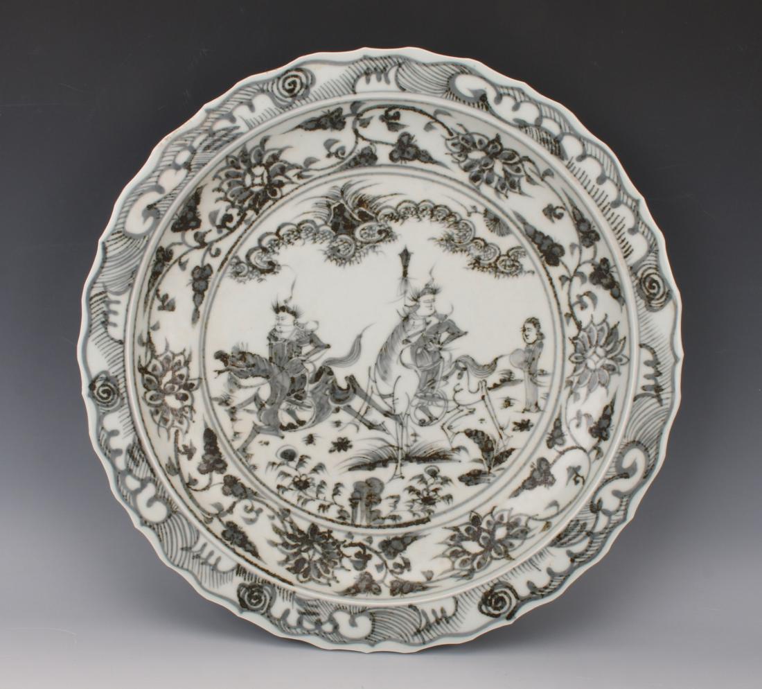 BLACK AND WHITE CHARGER WITH WARRIORS: BLACK AND WHITE CHARGER WITH WARRIORS : Warriors are in the center surrounded by a flower and tendril border. Two of the warriors are on horseback. The pie crust edge has a wave border. The outer rim