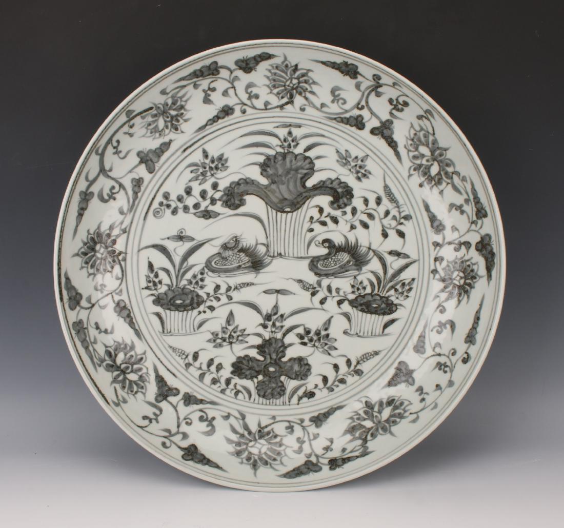 LARGE GRAY & WHITE CHARGER WITH DUCKS: LARGE GRAY & WHITE CHARGER WITH DUCKS : This charger is decorated with a water scene. Ducks are in the center surrounded by a flower and tendril border. The outer rim is a flower and tendril borde