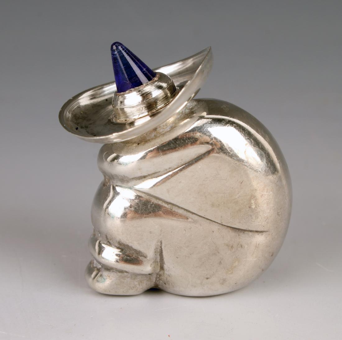VINTAGE MEXICAN STERLING PERFUME BOTTLE PIN: VINTAGE MEXICAN STERLING PERFUME BOTTLE PIN: A man is taking a siesta and wearing a sombrero. The sombrero screws off and has a perfume dauber. Blue glass cone that is the crown of the sombrero. Suita