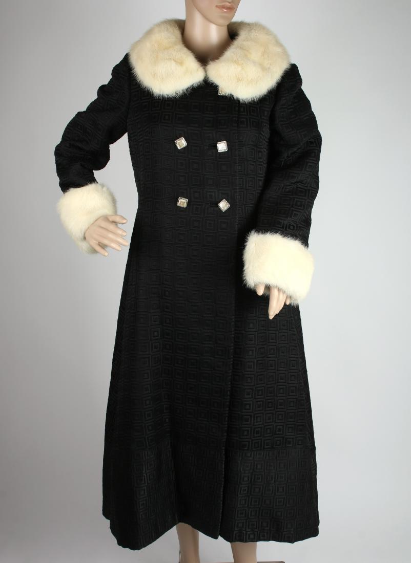 VINTAGE 1960S BLACK BROCADE & MINK EVENING COAT: VINTAGE 1960S BLACK BROCADE & MINK EVENING COAT: Finely made coat in black brocade square patterns with pearlized and rhinestone square buttons. The white mink collars and cuffs are still lustrous