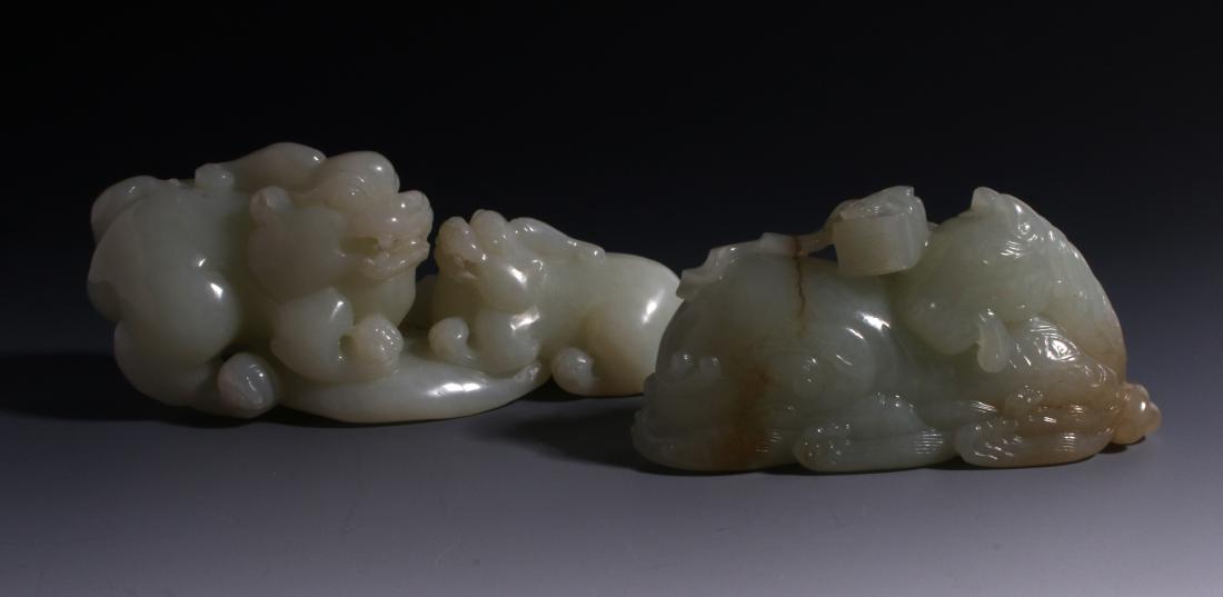CHINESE HAND CARVED JADE ANIMALS: CHINESE HAND CARVED JADE ANIMALS: Fine carved Chinese white jade of a larger and smaller foo dog facing each other in a crouching position baring their teeth. 3 1/2" X 1