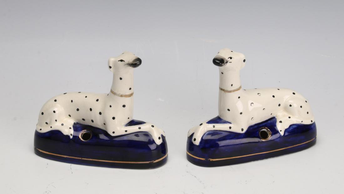 PAIR OF STAFFORDSHIRE DALMATIAN PEN HOLDERS: PAIR OF STAFFORDSHIRE DALMATIAN PEN HOLDERS: Two 1860 - 1880 Staffordshire Dalmatian pen holders in white with black spots and lounging on blue cushions. 5" X 1 1/2&quo