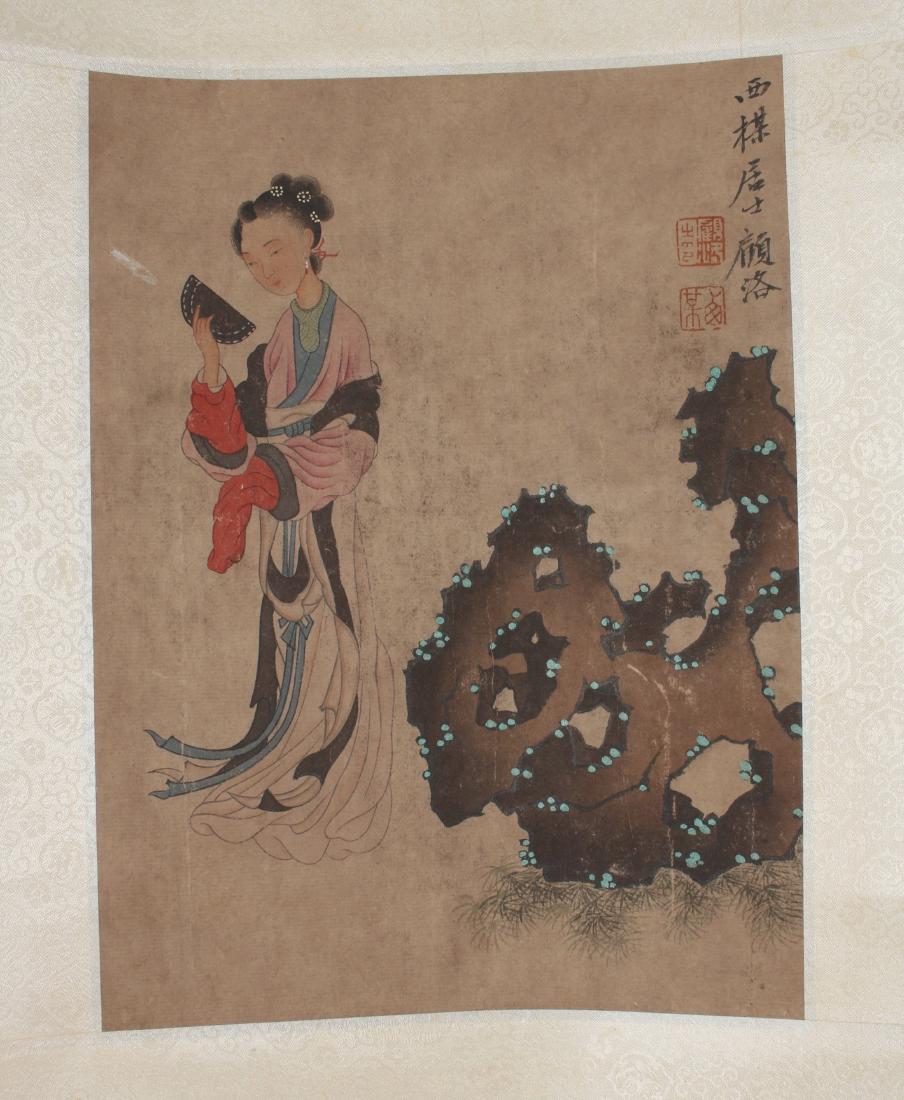 SCROLL OF BEAUTY IN A GARDEN: SCROLL OF BEAUTY IN A GARDEN: A beauty stands in a garden next to a boulder. Calligraphy and artist mark on right. 70" X 17 1/2" $400 - $600 Shi