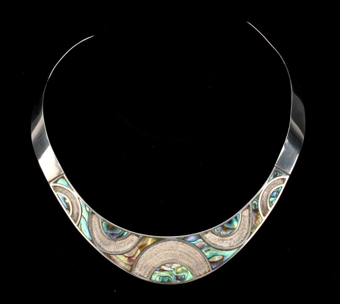 STERLING ABALONE MEXICAN NECKLACE: STERLING ABALONE MEXICAN NECKLACE: Dramatically inlaid with abalone. Arcs of textured silver further accentuate the iridescent mother of pearl areas. Stamped Mexico 925. $200 - $400 <