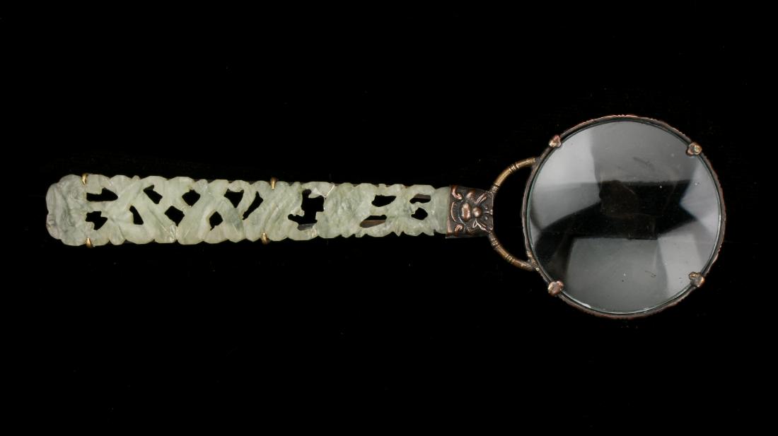 MAGNIFYING GLASS WITH JADE HANDLE: MAGNIFYING GLASS WITH JADE HANDLE: Pierced jade handle in ruyi and flower designs. Stamped China. 5 1/4" $200 - $400 Shipping:
