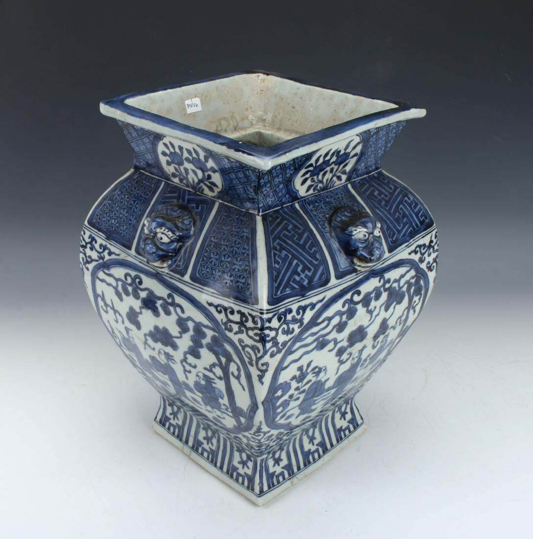 BLUE AND WHITE SQUARED VASE: BLUE AND WHITE SQUARED VASE: Blue and white vase with attached animal head handles. Square top that tapers to broad shoulders. The neck has a diapered pattern with floral reserves, the shoulder has a 