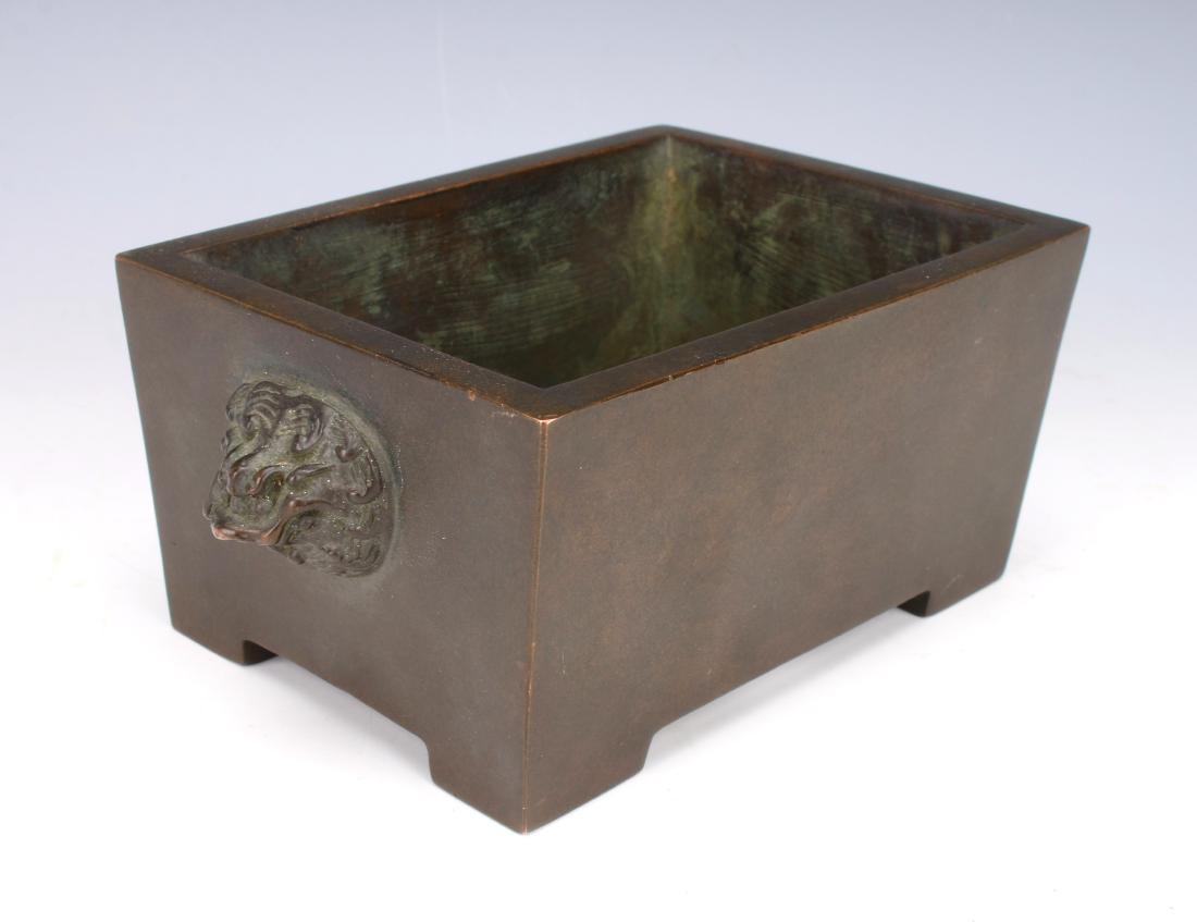 RECTANGULAR ANTIQUE BRONZE CENSER: RECTANGULAR ANTIQUE BRONZE CENSER: Rectangular censer with lion head handles and four feet. Marked on the bottom. 7" X 3/4" $600 - $900 Shipping
