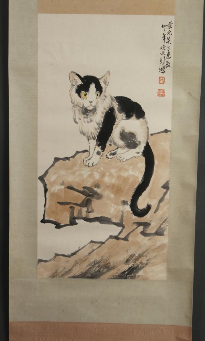 SCROLL OF BLACK AND WHITE CAT: SCROLL OF BLACK AND WHITE CAT: Black and white cat with yellow eyes perches on a boulder. Calligraphy and artist mark on right. 75" X 23 " $400 - $600