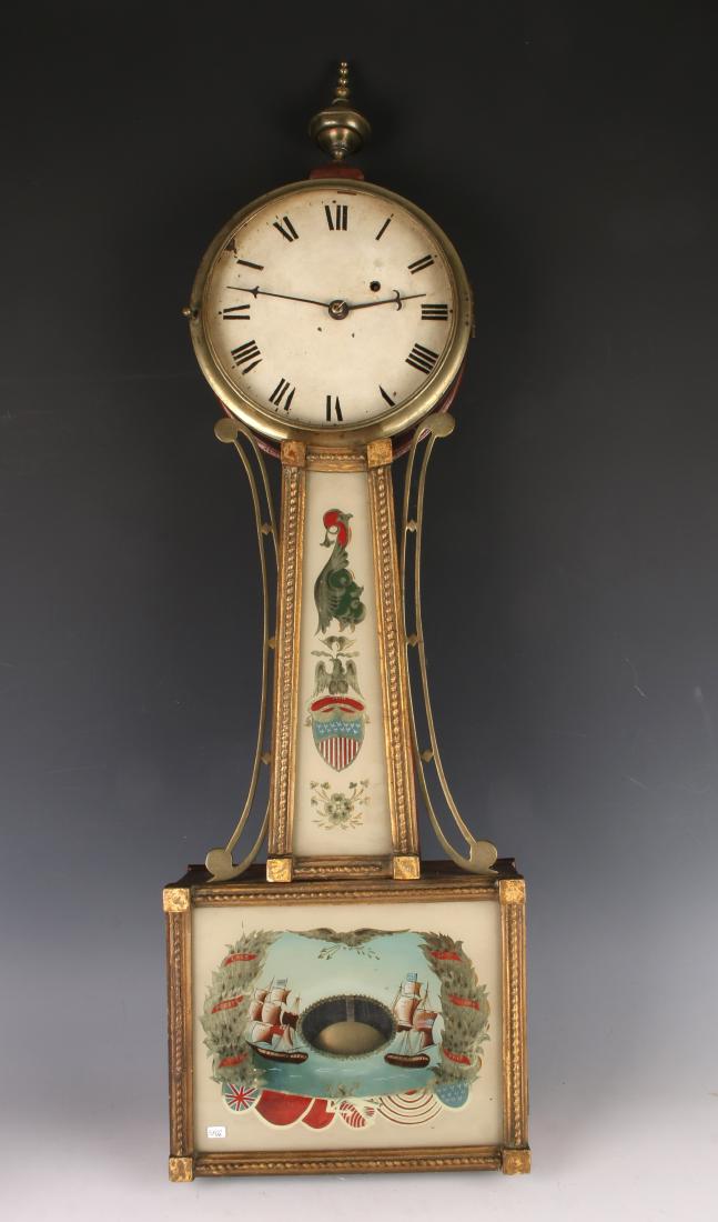 PRESENTATION BANJO CLOCK C. 1820: PRESENTATION BANJO CLOCK C. 1820: Throat glass is reverse painted and gilded in an American shield and a perched eagle. The bottom glass features sailing ships; says "Lake Erie Perry's Victory Se