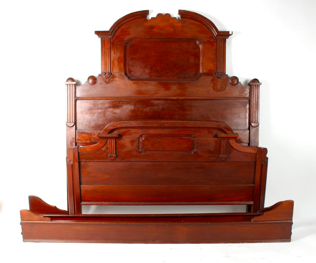 LATE VICTORIAN BED FRAME: LATE VICTORIAN BED FRAME: Headboard, footboard, and side rails. With burled panels, a curved footboard, and fluted columns on footboard and headboard. Headboard has a broke arch top. There is an area
