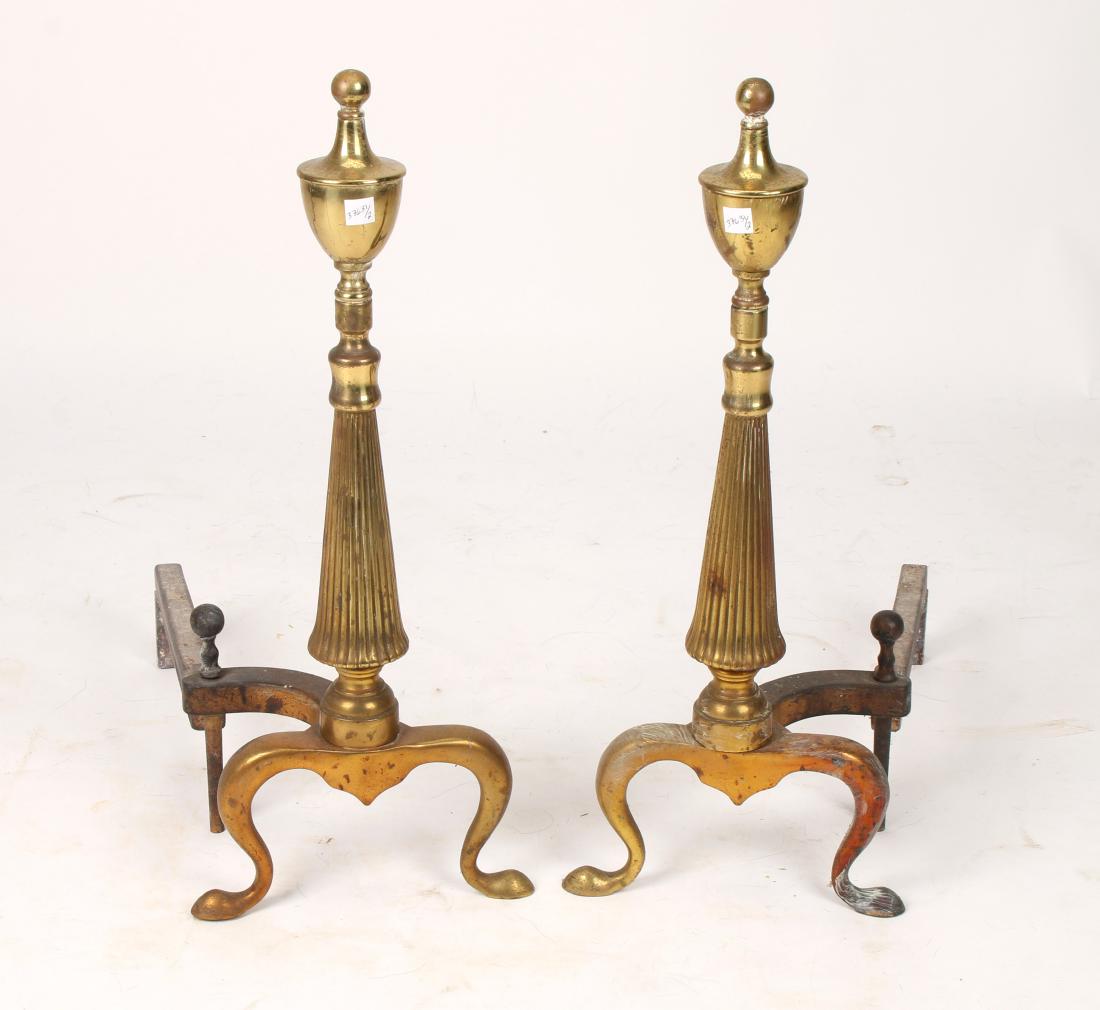 PAIR OF BRASS ANDIRONS: PAIR OF BRASS ANDIRONS: In an urn form finial with a fluted tapered column center. 9" X 14 1/2" X 21" $400 - $600 Shipping: