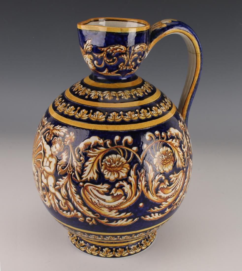 GIEN FAIENCE POTTERY PITCHER EWER: GIEN FAIENCE POTTERY PITCHER EWER: 19th C decorated with hand-painted mythological figures, floral and vine motifs. Renaissance design on cobalt blue ground, figural mask