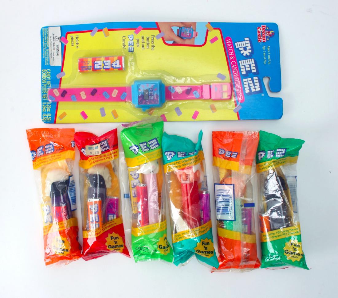 LOT OF PEZ DISPENSERS & WATCH WRAPPED: LOT OF PEZ DISPENSERS & WATCH WRAPPED: One Pez watch in package. Six wrapped themed Pez dispensers. 5" X 12" $40 - $80 Shipping: