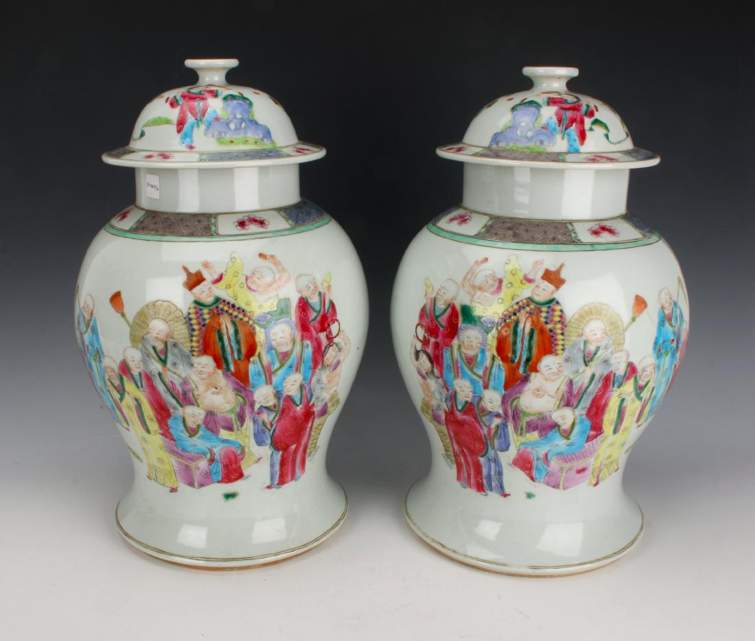PAIR OF IMMORTAL GINGER JARS: PAIR OF IMMORTAL GINGER JARS: Two large mirror ginger jars with immortals and court figures surrounding the body under clouds. The borders are alternating diapered patterns with bright pink flowers. M