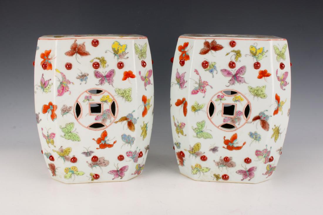 PAIR OF SMALL BUTTERFLY GARDEN SEATS: PAIR OF SMALL BUTTERFLY GARDEN SEATS: Many multicolored butterflies flutter around the body of the stools. The top and sides are pierced with a lucky coin design. 11" X