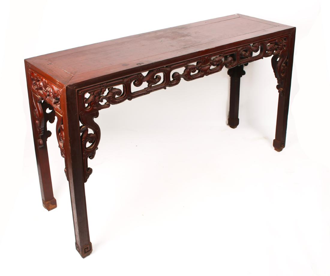 TALL LARGE CINNABAR LACQUERED PAINTING TABLE: TALL LARGE CINNABAR LACQUERED PAINTING TABLE: Unusually large painting table in a cinnabar lacquer finish. With carved and pierced Cloud and ruyi shapes on the apron and legs. Feet are incised in mean