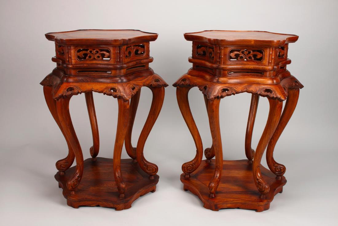 PAIR HUANGHUALI VASE STANDS: PAIR HUANGHUALI VASE STANDS: Two highly figured hexagonal vase stands that sit on six curved cabriole legs that terminate into hoofs. They have carved and pierced aprons with carved and scalloped pane