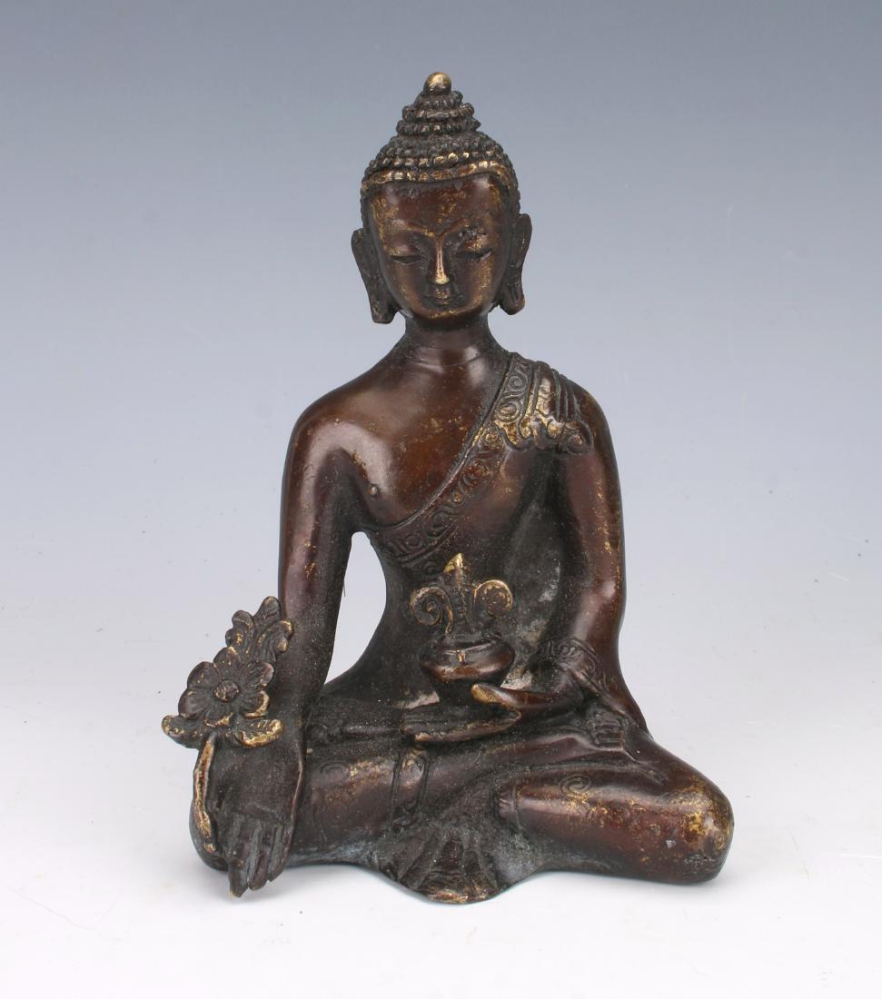 SMALL ANTIQUE BRONZE BUDDHA: SMALL ANTIQUE BRONZE BUDDHA: Small Buddha in lotus position. One hand is holding a flower, the other is holding a censer. Stylized flower mark on bottom. 3" X 4"