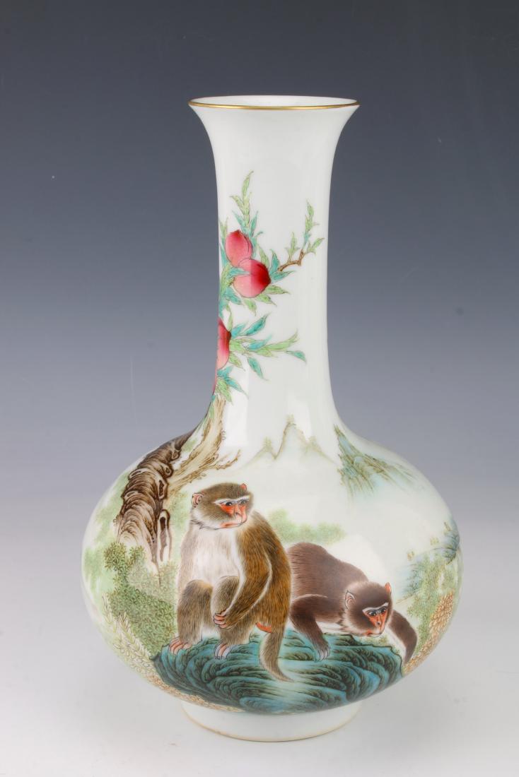 QIANLONG PORCELAIN BOTTLE VASE WITH GIBBONS: QIANLONG PORCELAIN BOTTLE VASE WITH GIBBONS: A pair of gibbons are under a peach tree on one side, a misty landscape is on the other side. Qianlong mark on the bottom. 6"