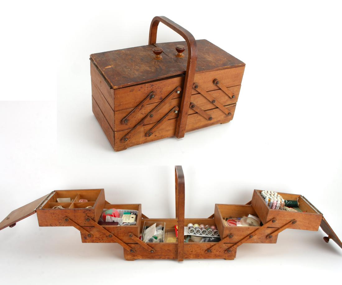 VINTAGE WOODEN EXPANDABLE SEWING BOX: VINTAGE WOODEN EXPANDABLE SEWING BOX: The box opens to reveal a bottom drawer with four drawers above, 2 on each side. Includes vintage sewing supplies. 15" X 7"