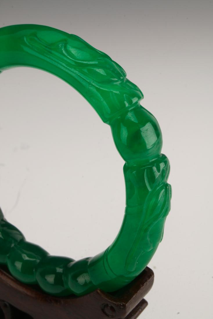 CHINESE DRAGON CARVED IMPERIAL GREEN JADE BANGLE: CHINESE DRAGON CARVED IMPERIAL GREEN JADE BANGLE: Ten pearl shaped 'beads' form the bottom of the bangle with one central pearl shape between the two dragon's faces. Look carefully at the crystalline 