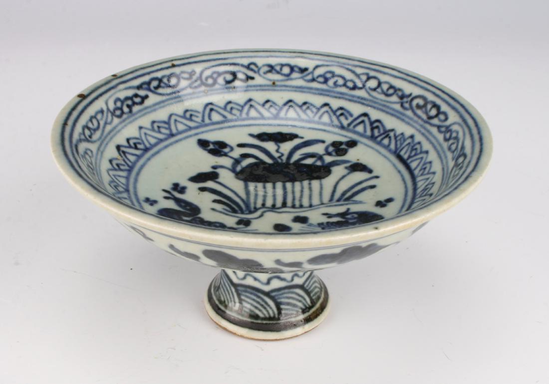 BLUE AND WHITE HIGH HEELED BOWL: BLUE AND WHITE HIGH HEELED BOWL: The inside has a water scene with ducks and lotus blossoms. The central scene has two borders of lotus and a tendril. The outer rim is flower and tendril, the foot is