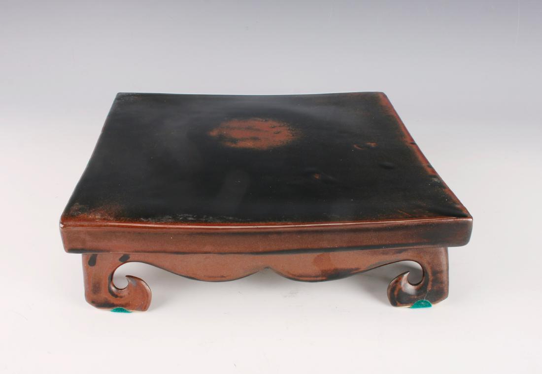 PORCELAIN VASE STAND: PORCELAIN VASE STAND: Low slightly concave stand on four feet. Marked and signed on the bottom. 9 1/2" X 9 1/2" X 3" $200 - $400 Shipping:<