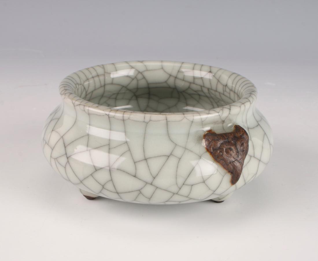 CHINESE PORCELAIN CRACKLE GLAZE CENSER: CHINESE PORCELAIN CRACKLE GLAZE CENSER: Tripod censer with a craquelure finish. Creature heads flank each side. Marked on the bottom. 4 1/4" X 2" $200 - $4