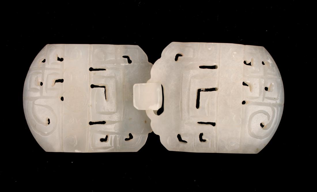 CARVED JADE BELT BUCKLE: CARVED JADE BELT BUCKLE : A belt buckle carved and pierced in geometric shapes with a character symbol on each piece . 4" X 1 3/4" $200 - $400 Sh