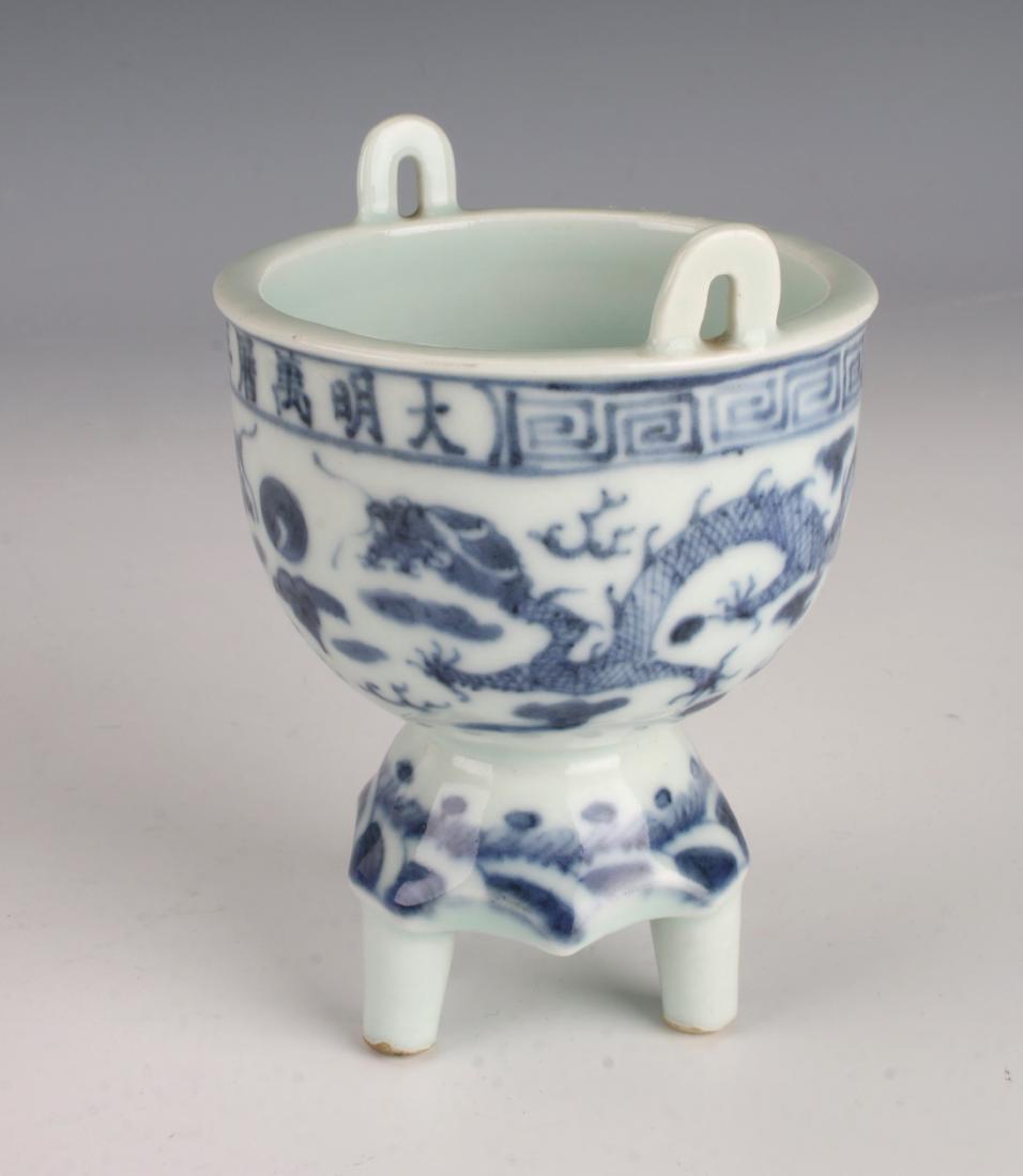 BLUE AND WHITE CENSER: BLUE AND WHITE CENSER : Loop handles on each side of the tripod censer. Dragons facing a pearl, six character mark on top rim. Top border is a meander. 3" X 4 1/2"<