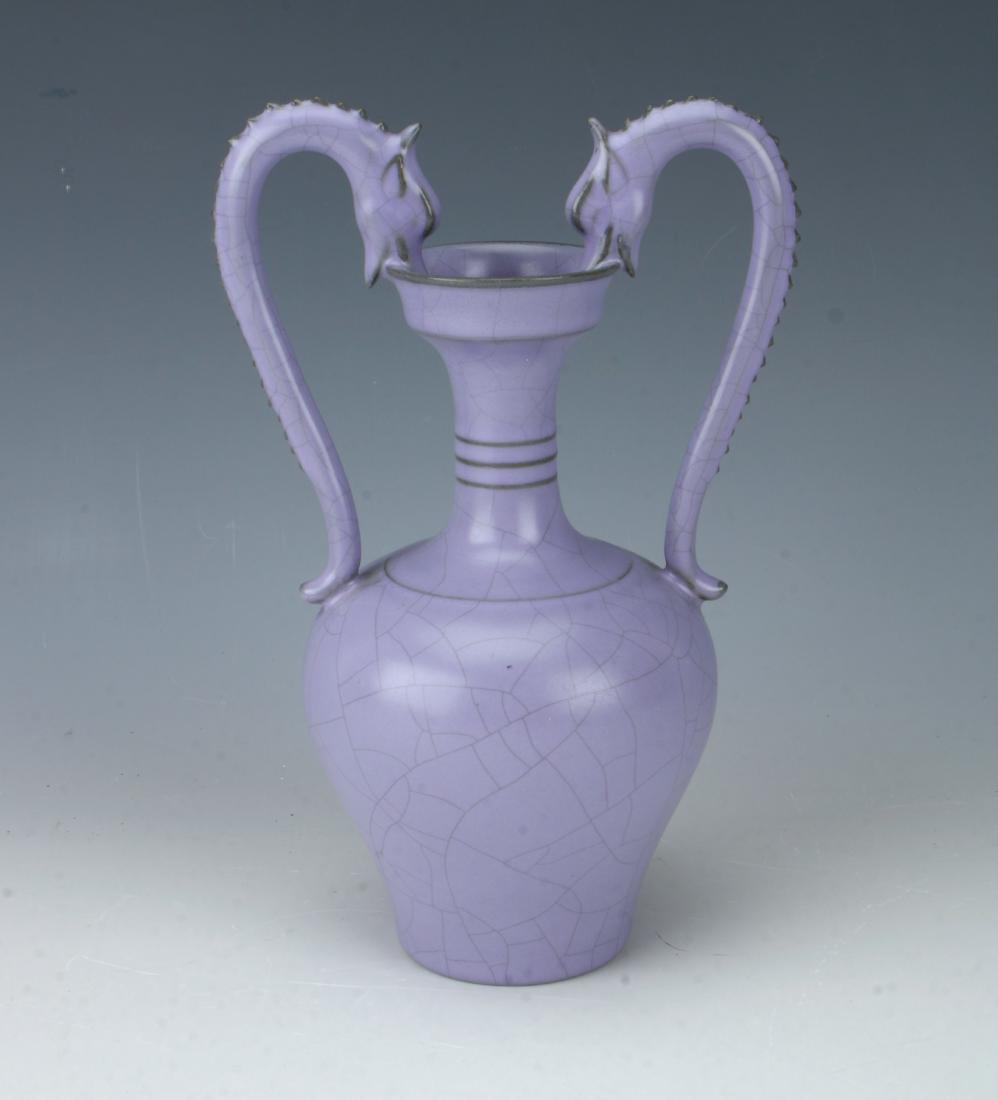LAVENDER DRAGON HANDLED AMPHORA VASE: LAVENDER DRAGON HANDLED AMPHORA VASE : Pierced dragon form handles grasp the rim in their mouths on this urn form amphora vase. Marked on the bottom. 4 1/2" X 7"