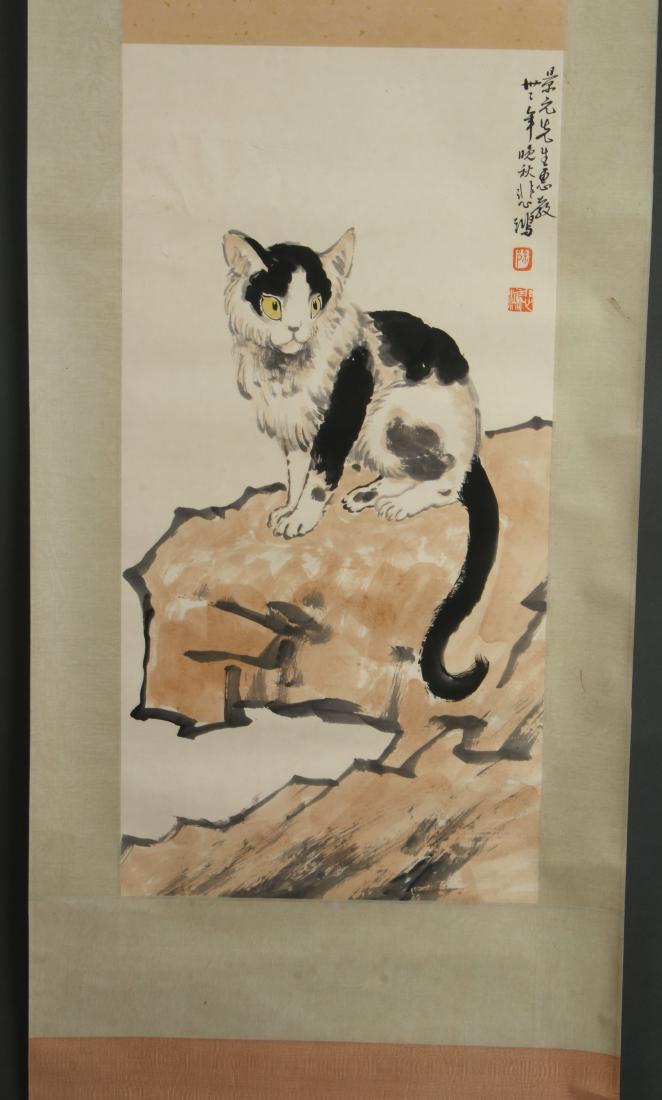 SCROLL OF BLACK AND WHITE CAT: SCROLL OF BLACK AND WHITE CAT: Black and white cat with yellow eyes perches on a boulder. Calligraphy and artist mark on right. 75" X 23 " $400 - $600