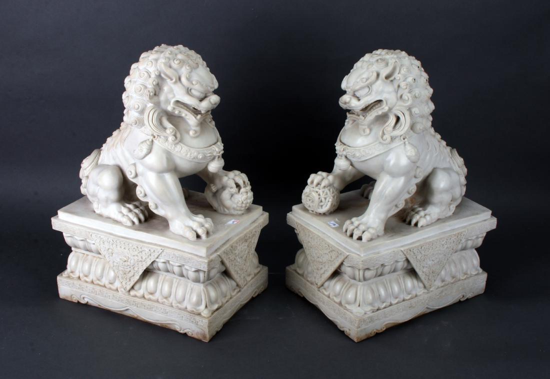 PAIR OF IMPRESSIVE HEAVY CARVED FOO DOGS SHI SHI: PAIR OF IMPRESSIVE HEAVY CARVED FOO DOGS SHI SHI: They are both perched on double lotus pedestals. One foo dog has a paw on a puppy, the other has a paw on the ball. Each foo dog is carved in great de