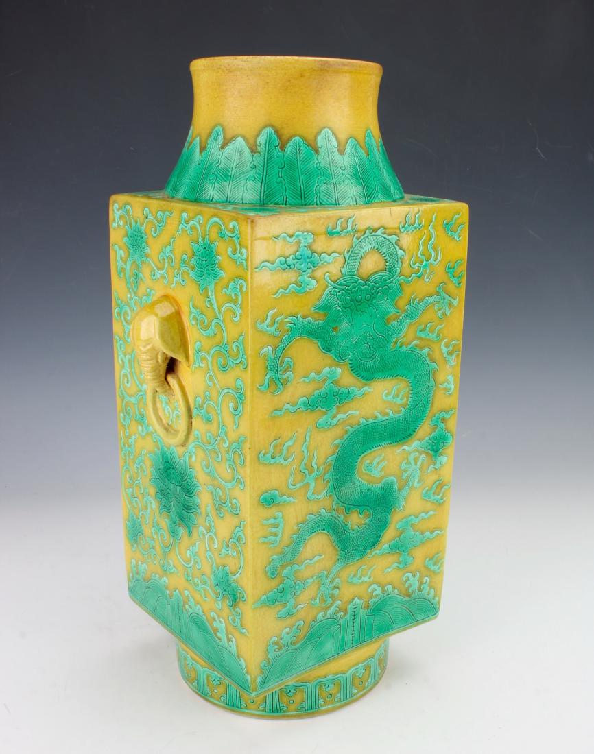FAMILLE JUANE SQUARE DRAGON VASE: FAMILLE JUANE SQUARE DRAGON VASE : Elephant handles with attached rings flank the neck. The whole vase has incised designs with green glaze. The neck has a plantain border with a flower in each corner