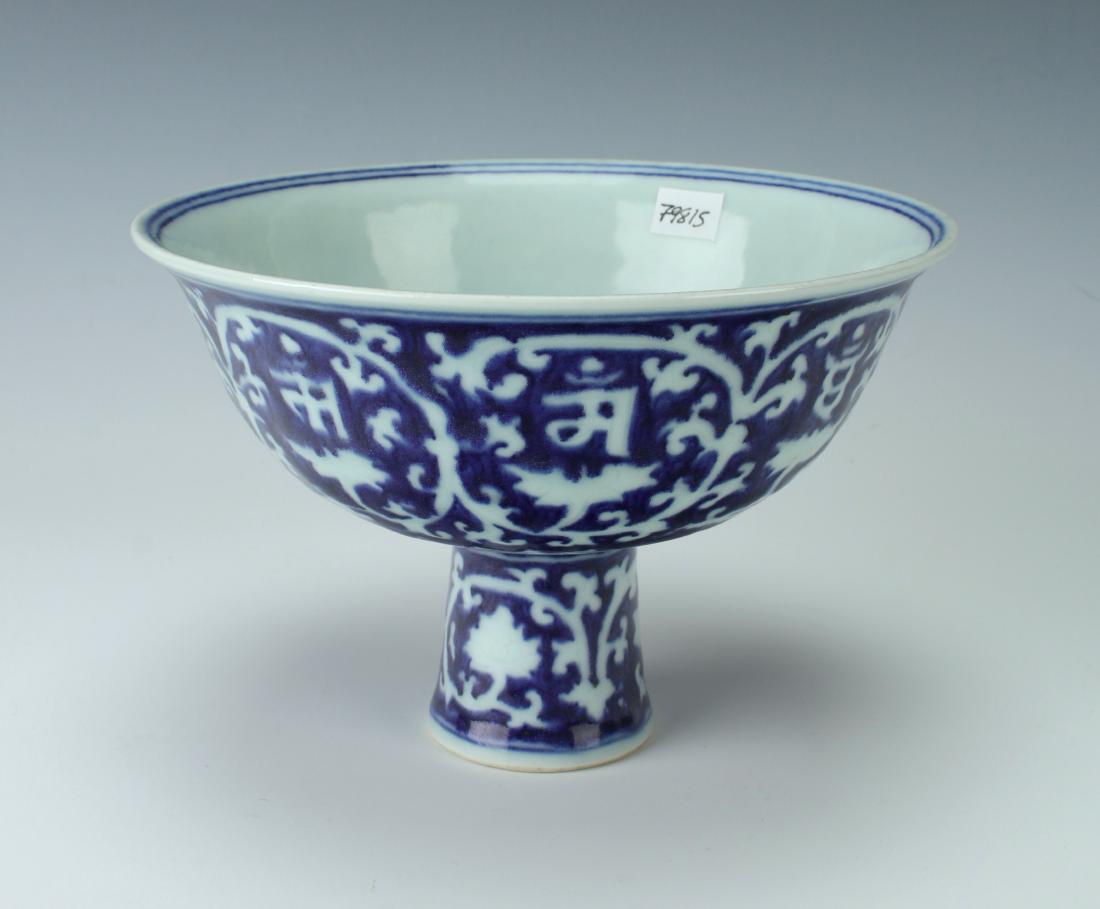 BLUE & WHITE HIGH HEELED BOWL: BLUE & WHITE HIGH HEELED BOWL: There is a six character mark on the interior of the bowl. It is decorated in circular vines, each containing a flower and character. All this over a lotus petal bor