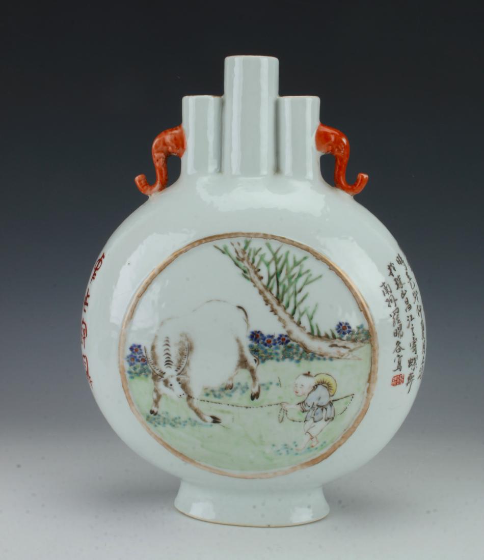 CHINESE PORCELAIN REPUBLIC VASE: CHINESE PORCELAIN REPUBLIC VASE: The vase is in a moon flask shape with three openings at the top. Pierced orange elephant head handles on either side of the openings. Circular reserve with a boy lead