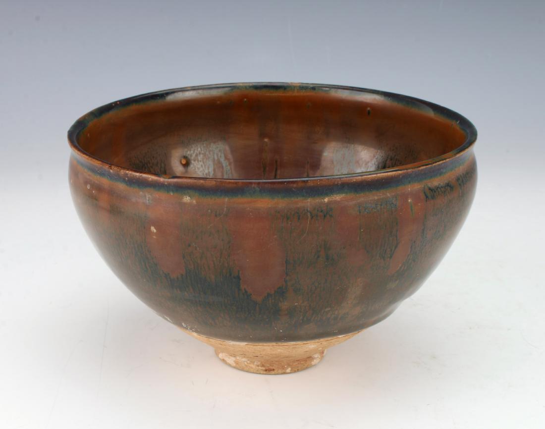 HARES FUR BOWL: HARES FUR BOWL: In warm browns and blacks, the interior has a radiating pattern of drips. The exterior is a sibtle hare's fur pattern. The thick glaze stops at the unglazed foot.
