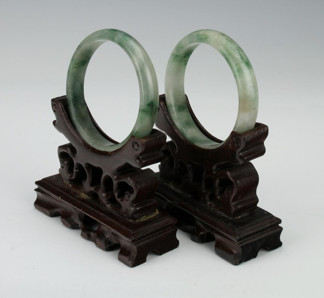 TWO MOTTLED JADE BANGLES (1 of 6)