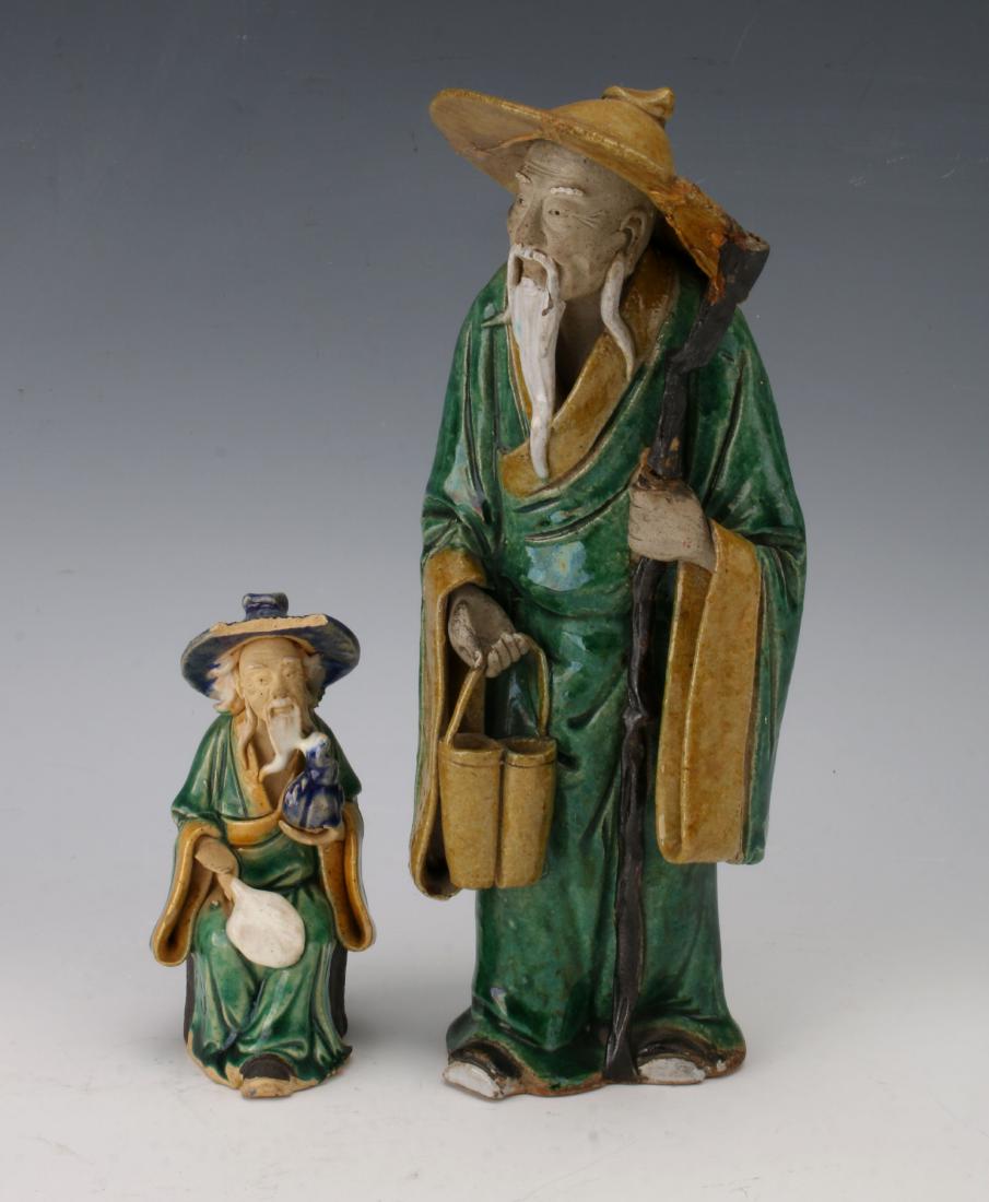 TWO PORCELAIN MUDMEN: TWO PORCELAIN MUDMEN: Two porcelain mudmen with blue, green, and yellow ochre glazes. White beards and green robes. 9" X 3 1/2" $40 - $80 Shippi