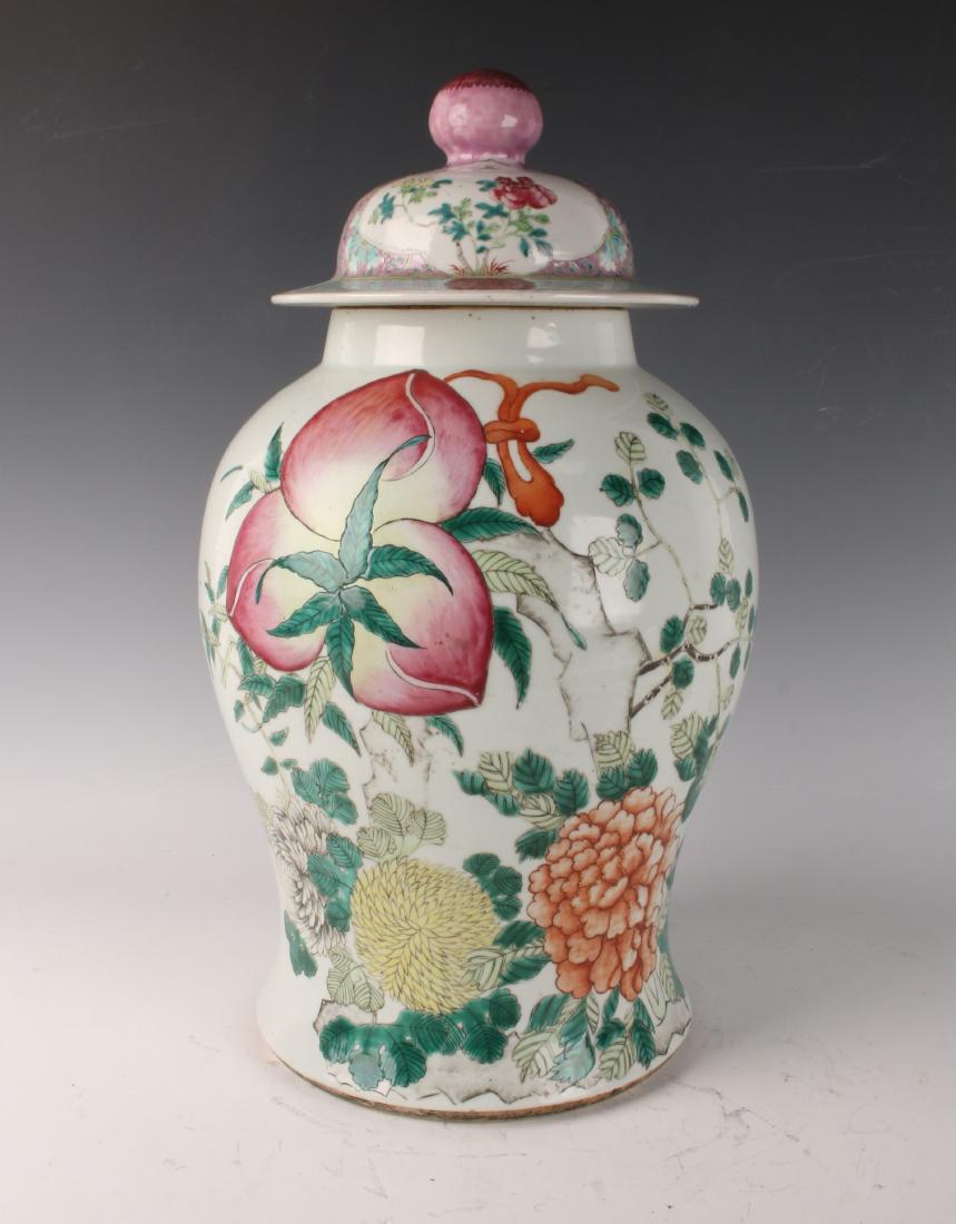 FAMILLE ROSE PEACH GINGER JAR: FAMILLE ROSE PEACH GINGER JAR: Large ginger jar with ripe peaches and flowers on the body. A peach finial tops the lid decorated with flowers. Calligraphy is on the back. Drilled through on the bottom