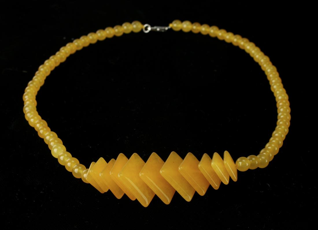 YELLOW JADE CHOKER WITH ROUND AND SQUARE BEADS: YELLOW JADE CHOKER WITH ROUND AND SQUARE BEADS: Round beads are interrupted by graduating square jade beads. 8 1/2" $200 - $400 Shipping:
