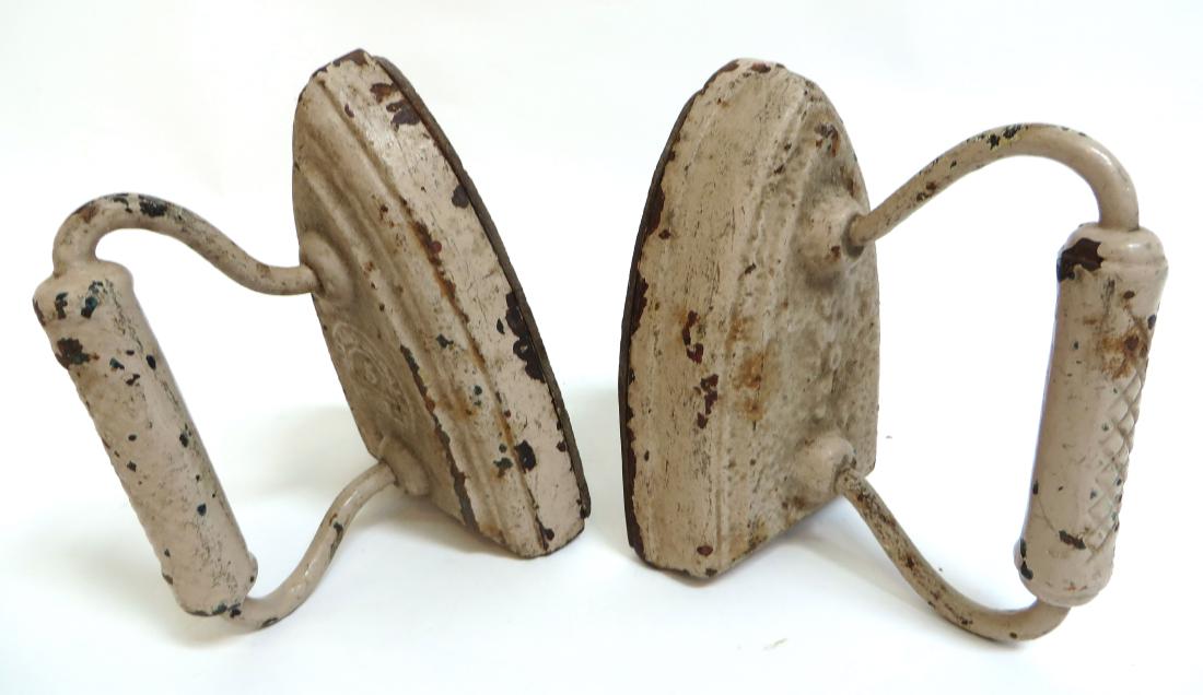 TWO IRON DOORSTOPS IN CAST IRON (1 of 4)