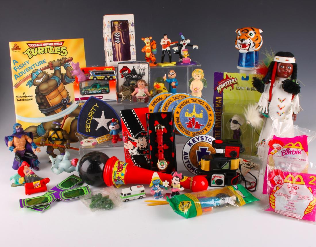 ASSORTED LOT OF CARTOON BASED FIGURES: ASSORTED LOT OF CARTOON BASED FIGURES: Two Ringling Brothers flashlights. Betty Boop watch. Indian Art Eskimo doll. Two McDonald's happy meal toys. Three micro mini cameras. Barbie key chain. Pez disp