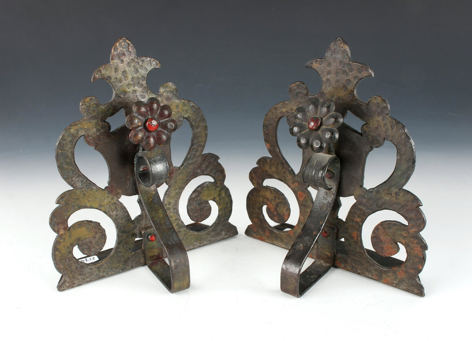 HAND HAMMERED ARTS & CRAFTS BOOKENDS: HAND HAMMERED ARTS & CRAFTS BOOKENDS: With pierced curvilinear design and painted red accents. 5 1/2" X 6 1/2" $100 - $200 Shipping: