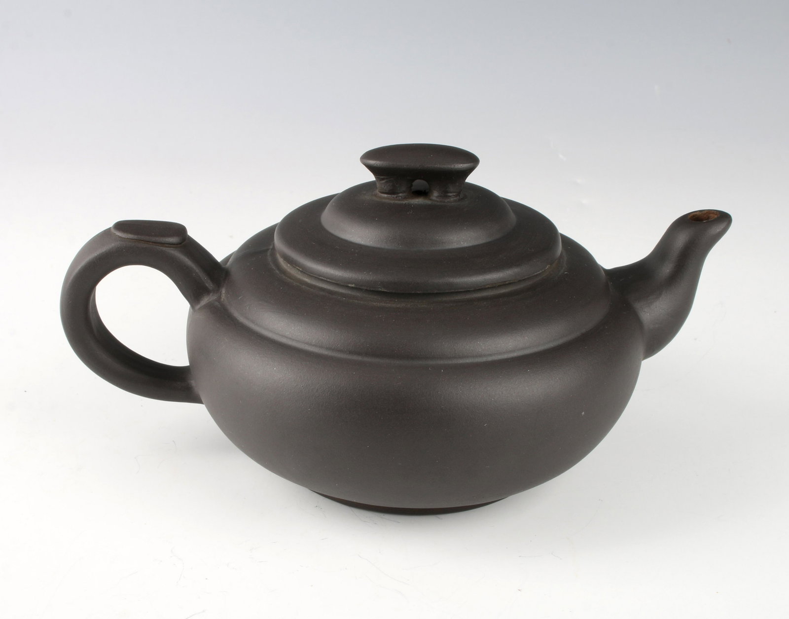 CERAMIC TEA KETTLE: CERAMIC TEA KETTLE: A simple lidded tea pot with finial and looped handle. Marked on the bottom. 7" X 4" $40 - $80 Shipping: