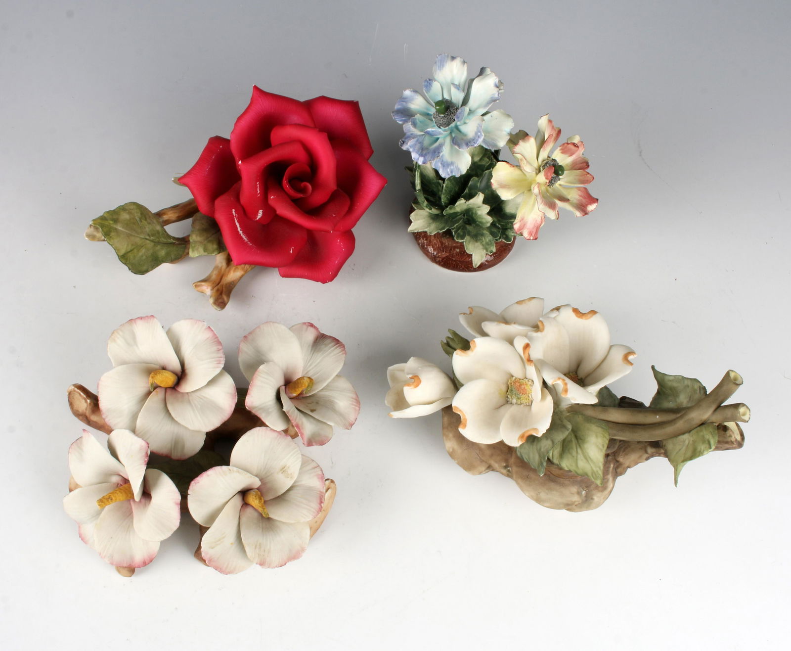 4 CAPODIMONTE PORCELAIN FLOWER GROUPINGS: 4 CAPODIMONTE PORCELAIN FLOWER GROUPINGS: Life sized flowers on realistic branches delicately made and brightly colored. A charming addition to any table top arrangement. 7&q