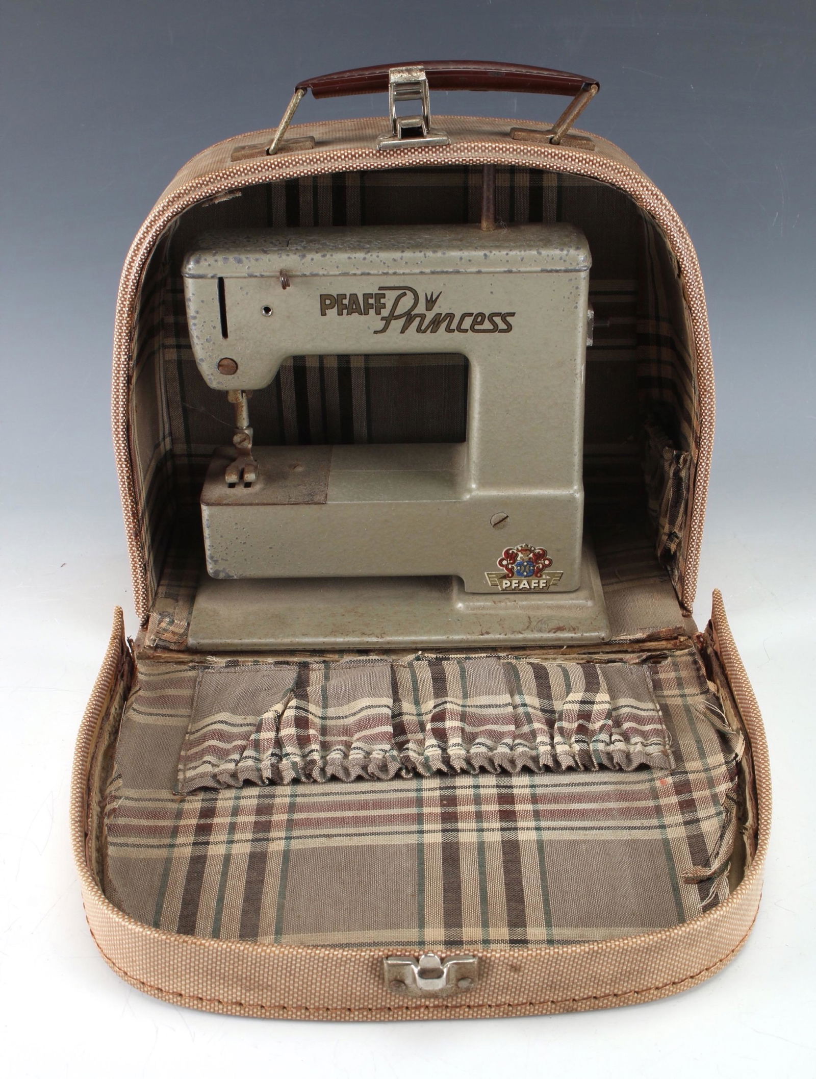 PFAFF PRINCESS MINI SEWING MACHINE IN CASE: PFAFF PRINCESS MINI SEWING MACHINE IN CASE: In original carrying case lined in a near Burberry plaid. Machine fits neatly in to the arched case. Made in Germany. Lift on presser foot functions.